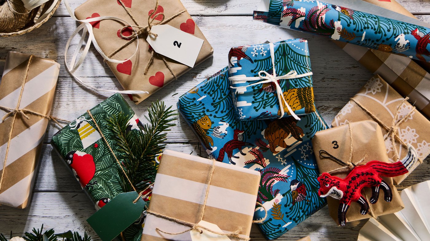 Christmas presents encased in VINTERFINT gift wrapping with heart, stripe, and Swedish forest themed motif.