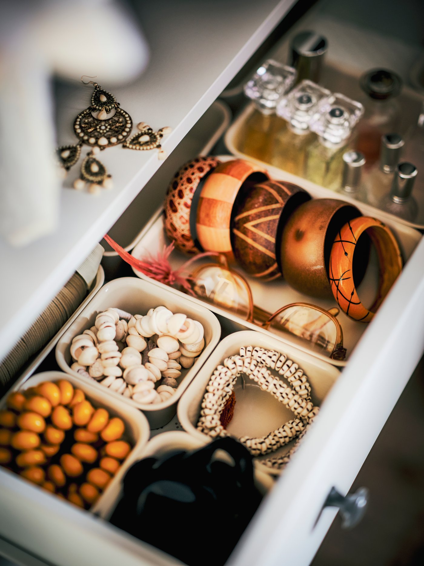 A plastic/beige NOJIG organiser in the bedroom