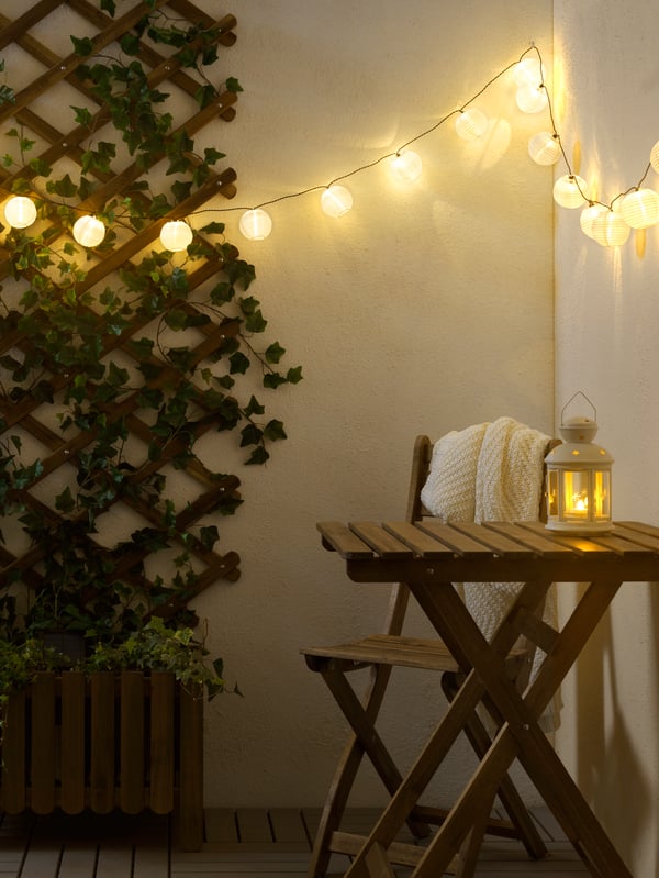 An in/outdoor white ROTERA lantern for tealight outside
