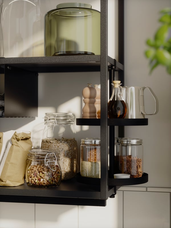 KORKEN storage jars with lids and CITRONHAJ spice jars on an ENHET turntable in an anthracite‑coloured ENHET wall cabinet with shelves
