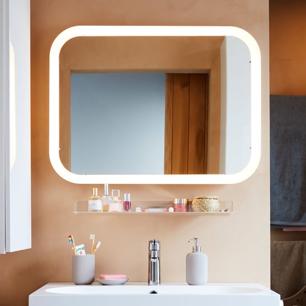 A beige EKOLN soap dispenser