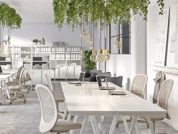 Indoor office space with large tables and rotating chairs 