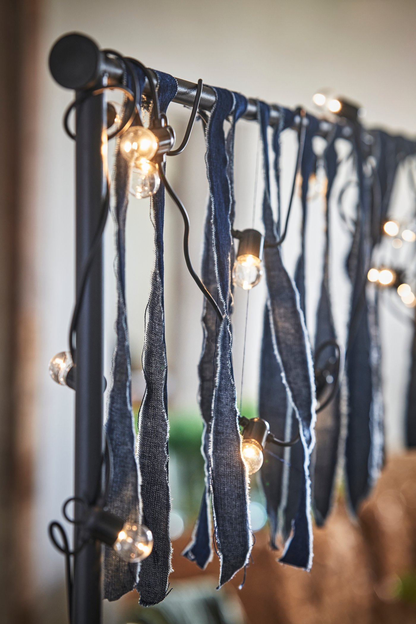A black adjustable/outdoor indoor  HELGEÖ decorating rod for table