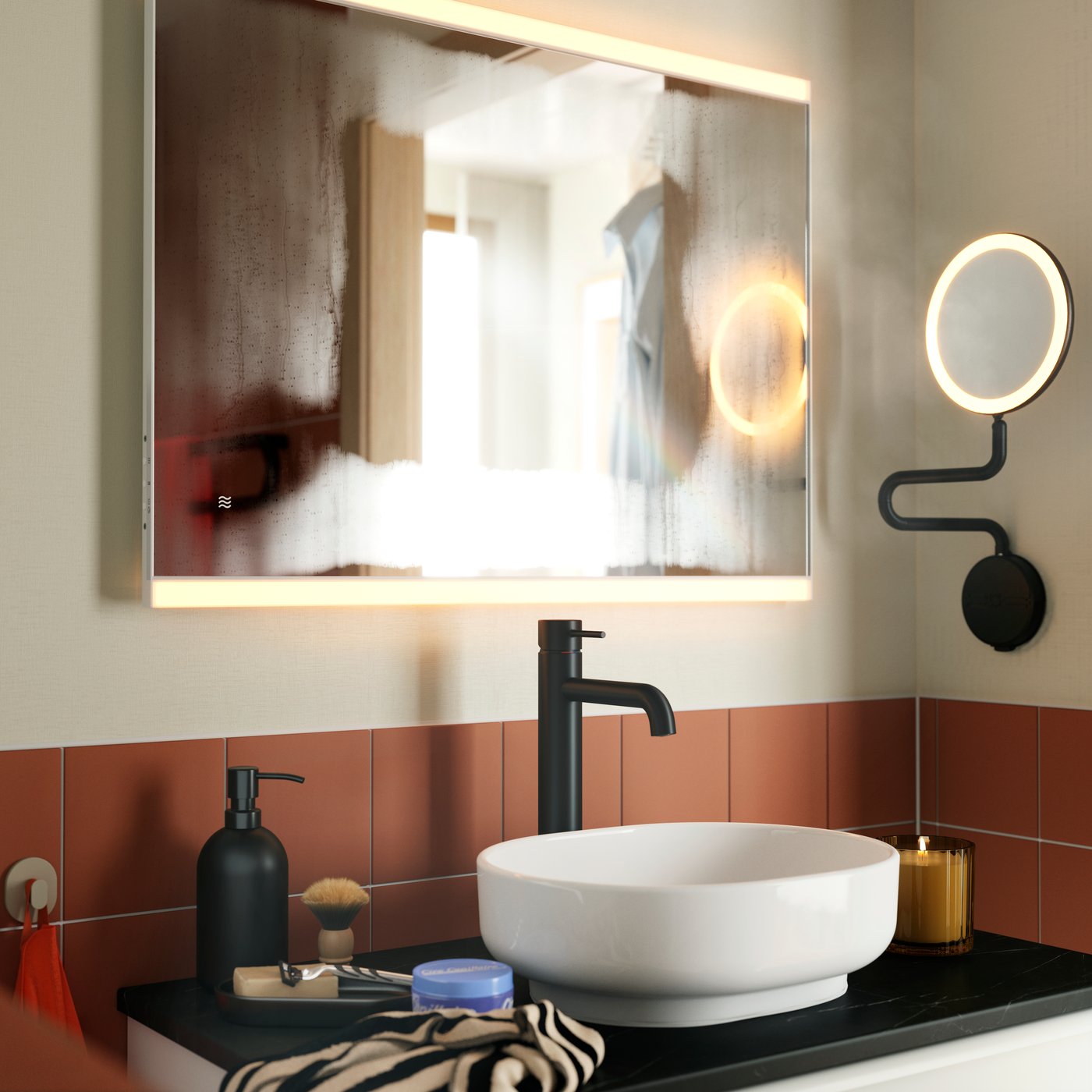 A KÄRRSJÖN mirror with integrated lighting mounted above a round washbasin and black tap, in a terracotta-tiled bathroom.
