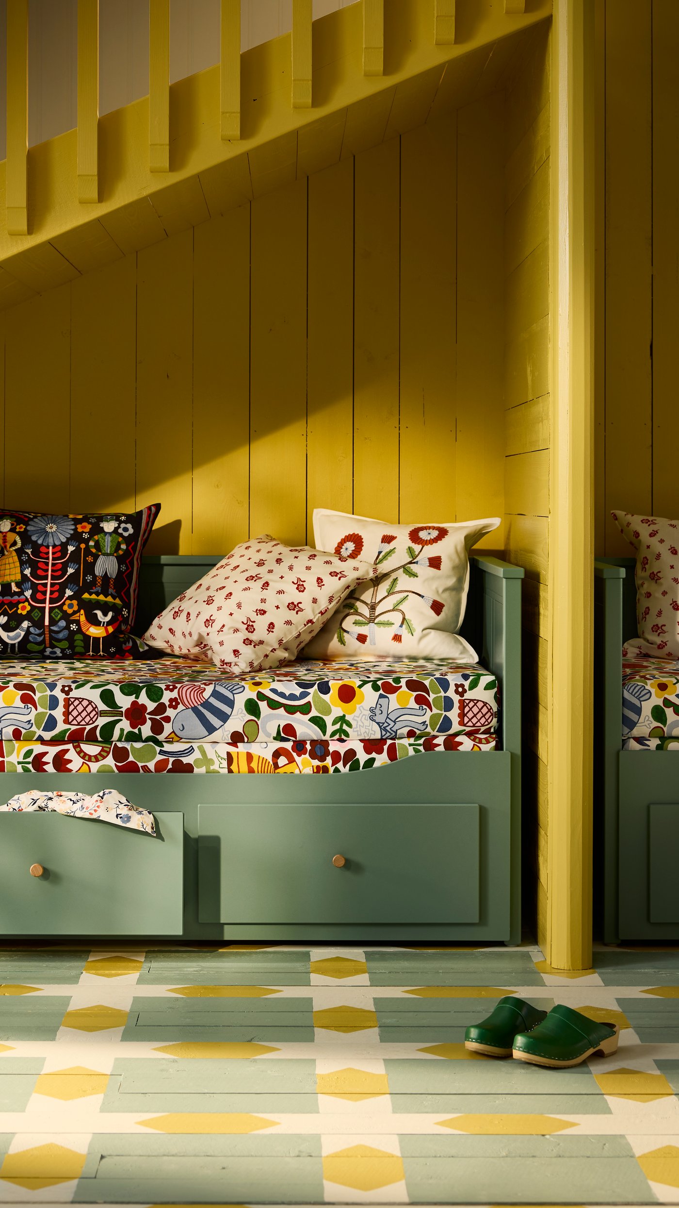 A grey-green HEMNES day-bed frame with 3 drawers in the living room
