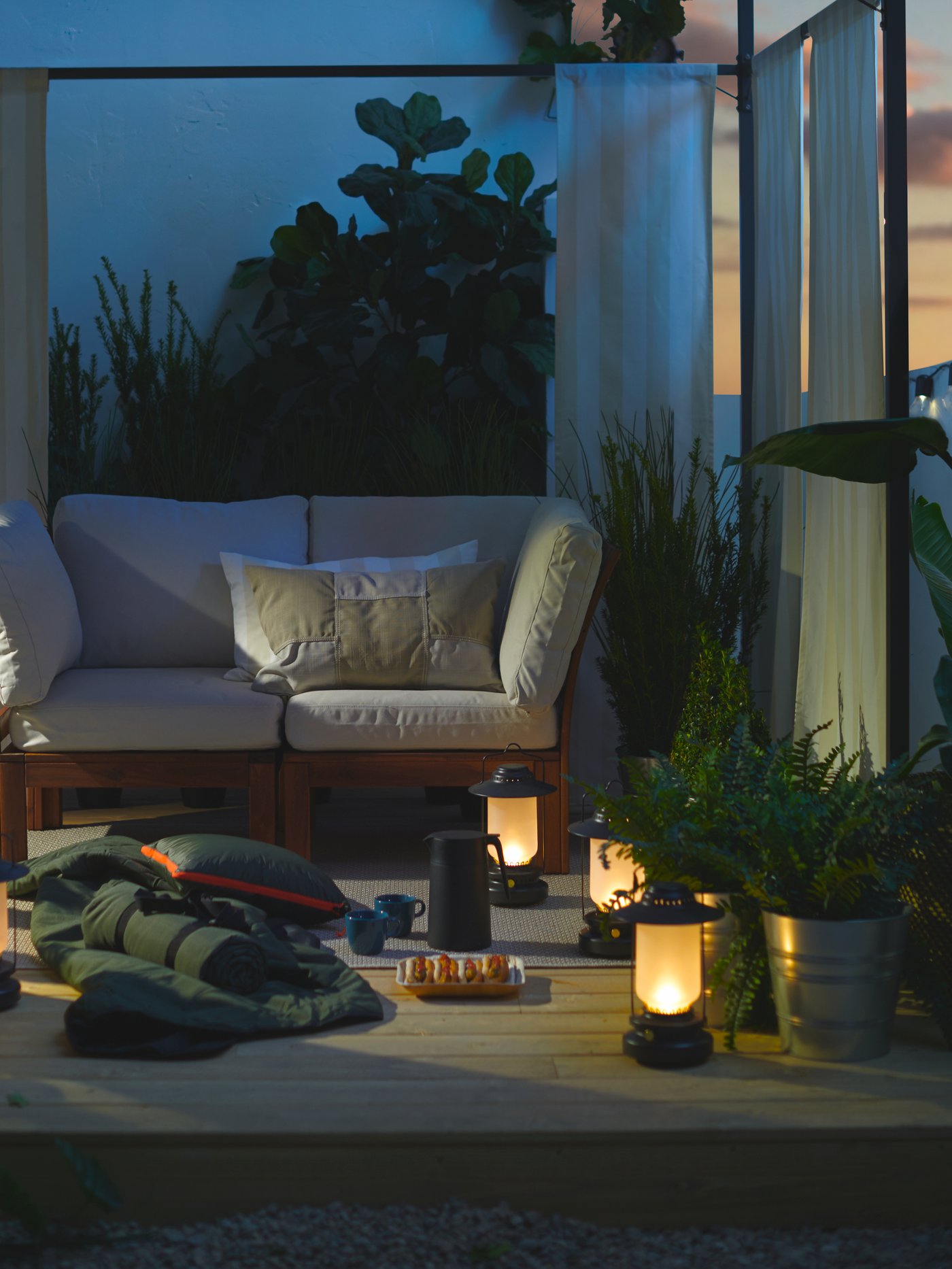 LED lanterns, a blanket, hot dogs and warm drinks under a gazebo on the deck at dusk create a camp-like getaway.