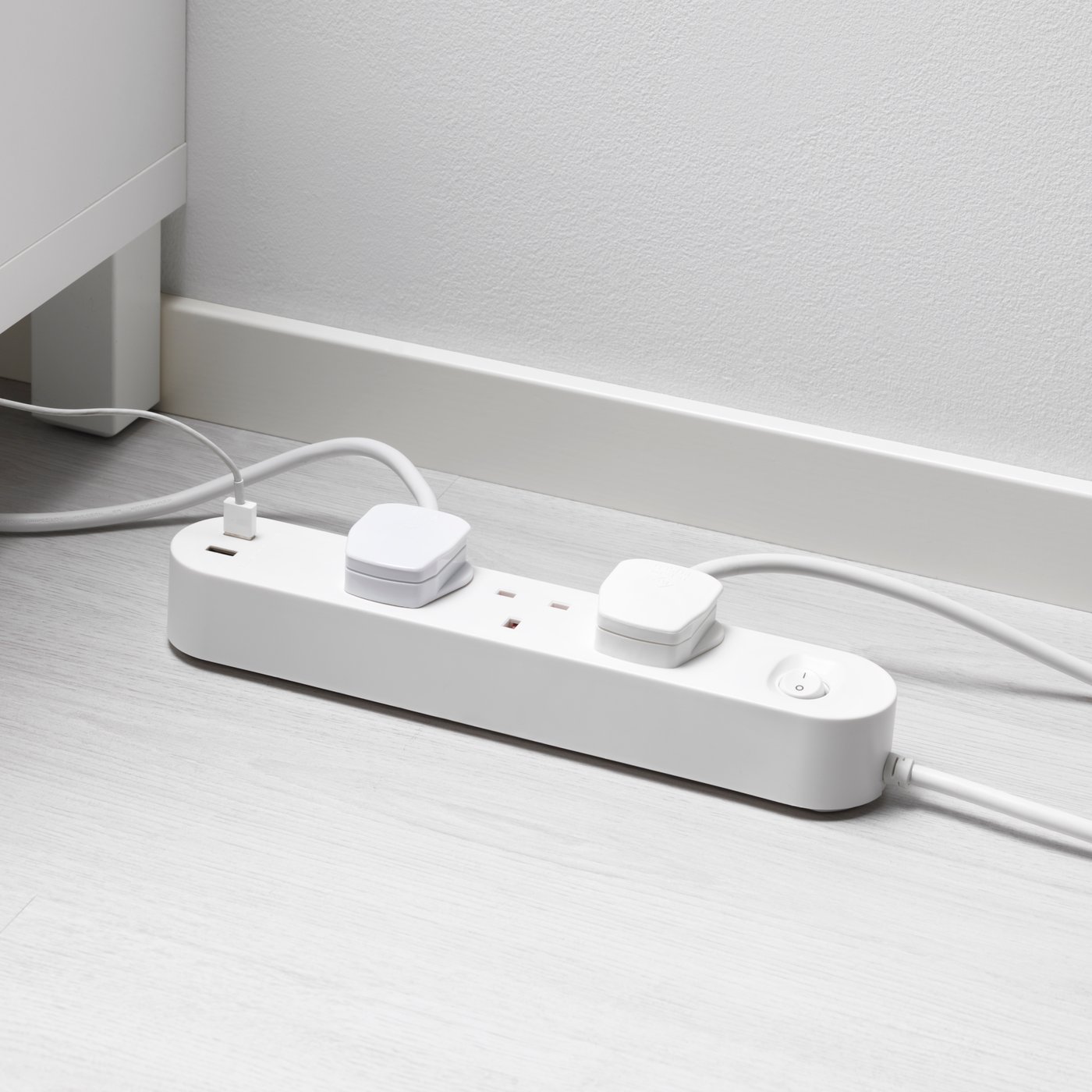 A close-up shot of a white KOPPLA 3-wat socket with 2 USB ports.
