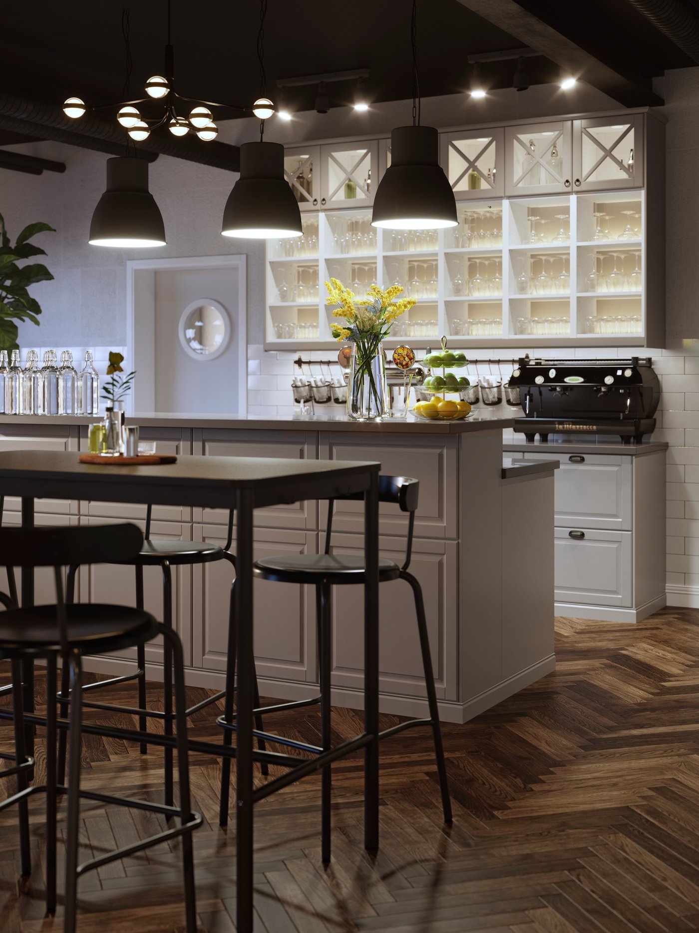 Table haute TOMMARYD anthracite et chaises hautes anthracite formant un espace bar, devant une cuisine ouverte gris clair.