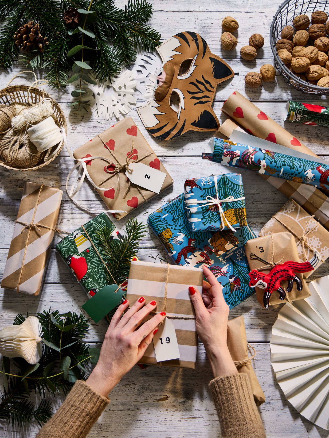 Christmas presents encased in VINTERFINT gift wrapping with heart, stripe, and Swedish forest themed motifs.
