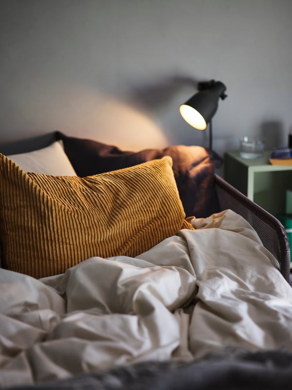 A dark beige ÅSVEIG cushion cover