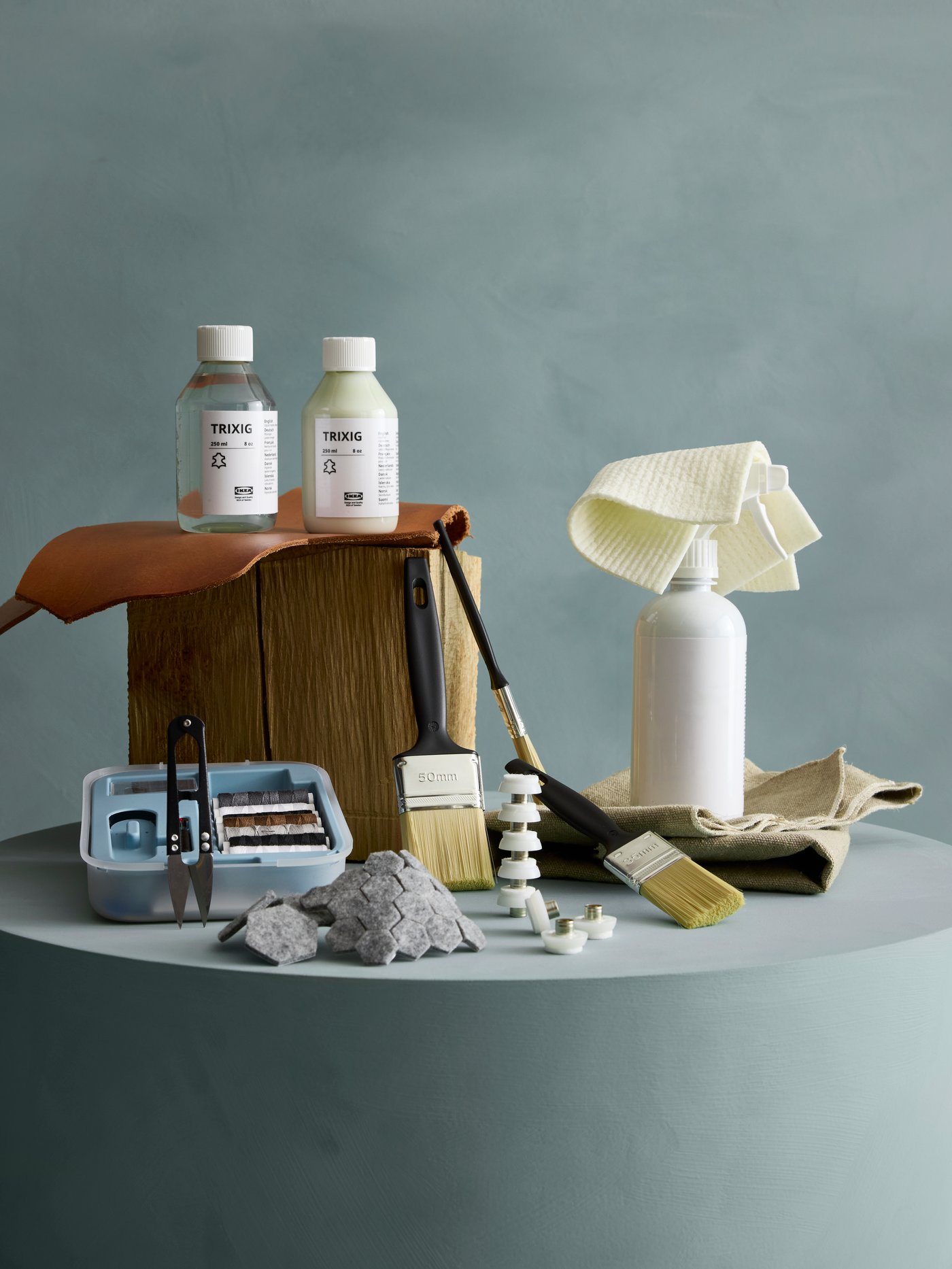 Close up of the TRIXIG range of care and repair products placed on a piedestal.