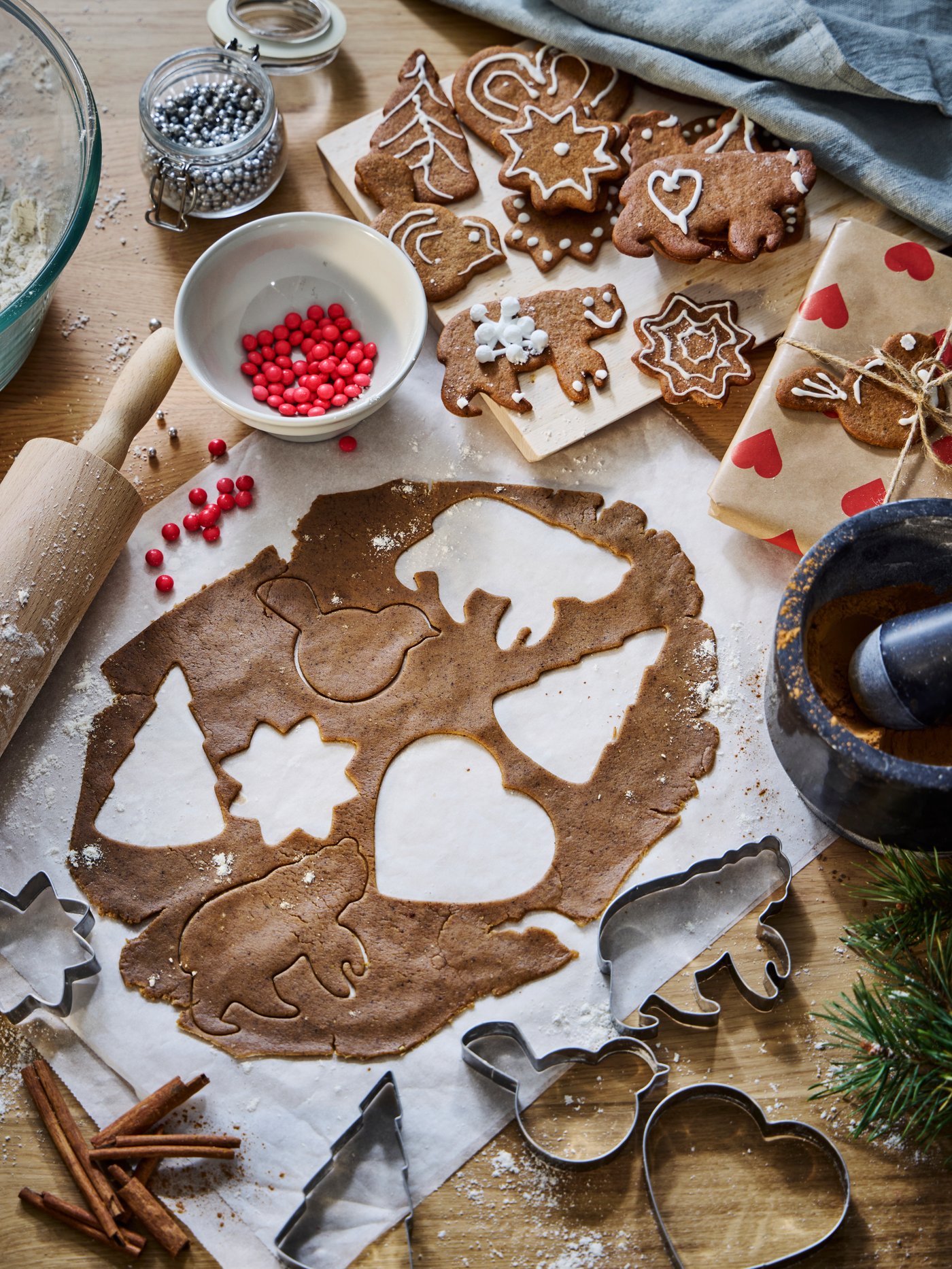 Gingerbread dough being cut into bird, bear, tree, heart and star shapes using VINTERFINT pastry cutters.