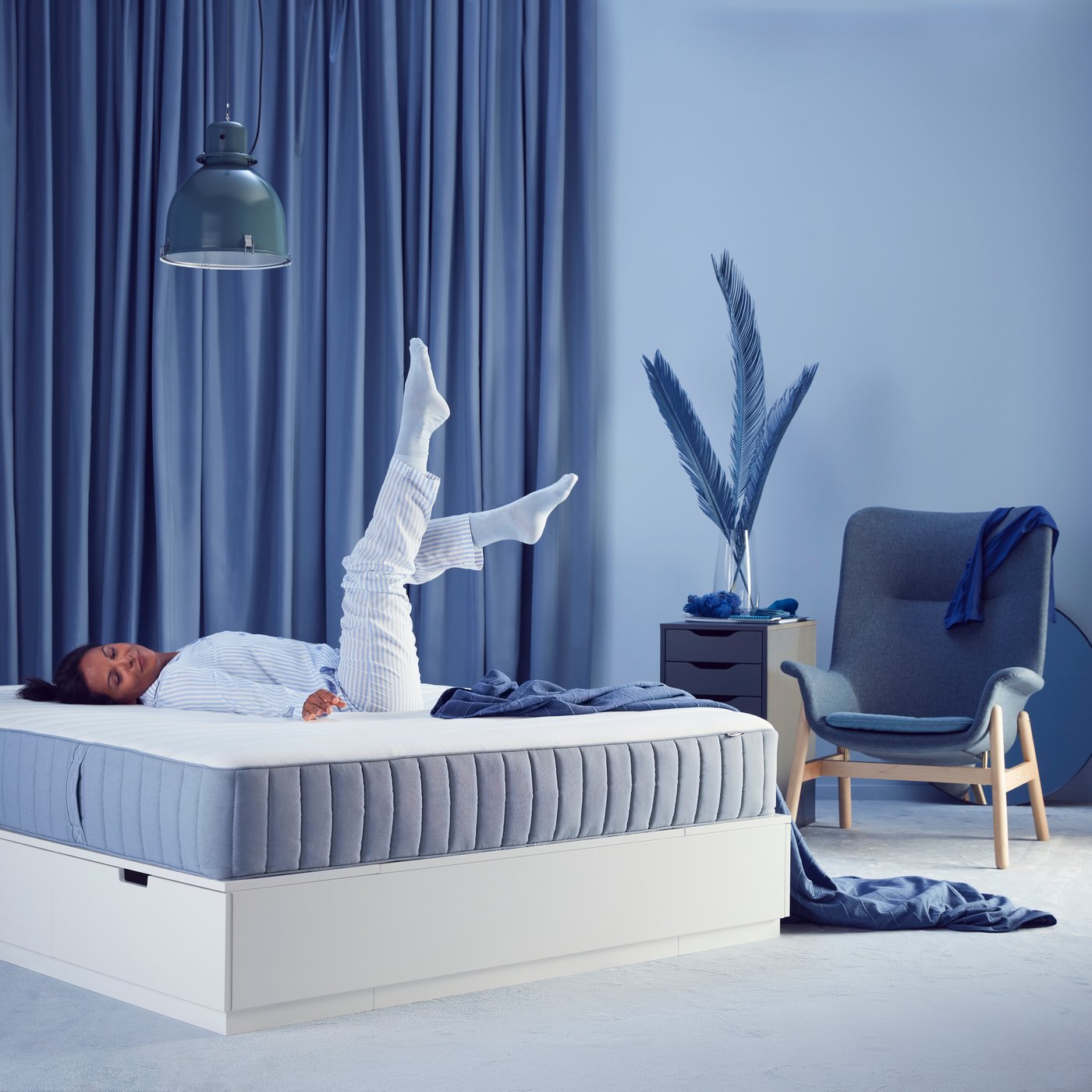 A firm/light blue VALEVÅG pocket sprung mattress in the bedroom