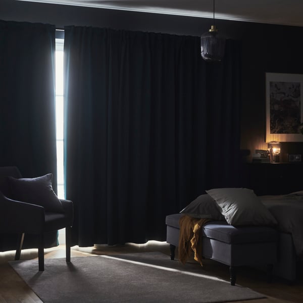 Block out curtains covering the windows leaving only a small gap in the middle where the two ends of the curtain meet