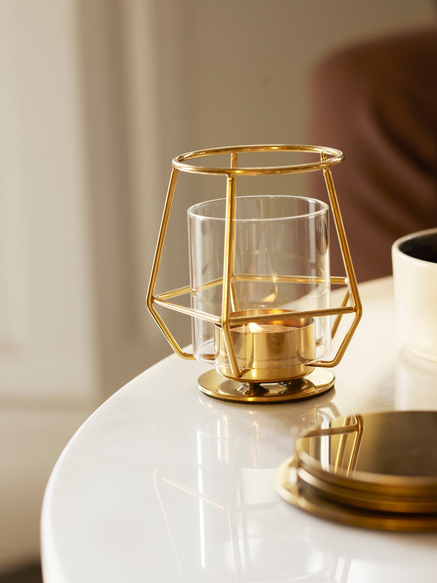 A gold lit tea light sitting on a table