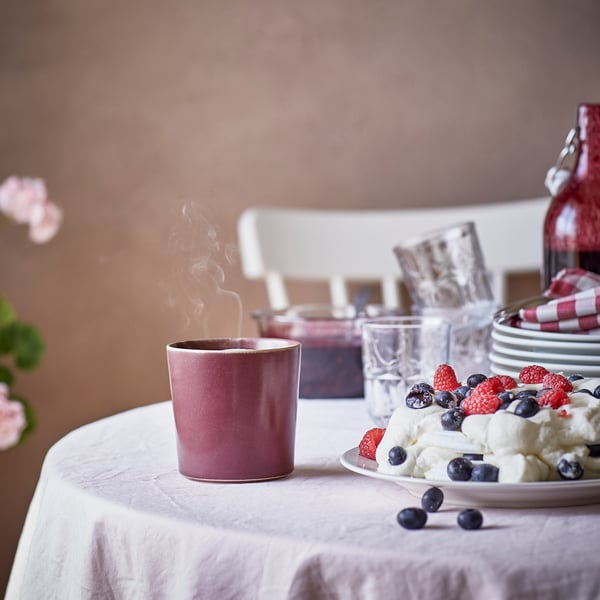 A Berries/red STÖRTSKÖN scented candle in ceramic jar in the dining room