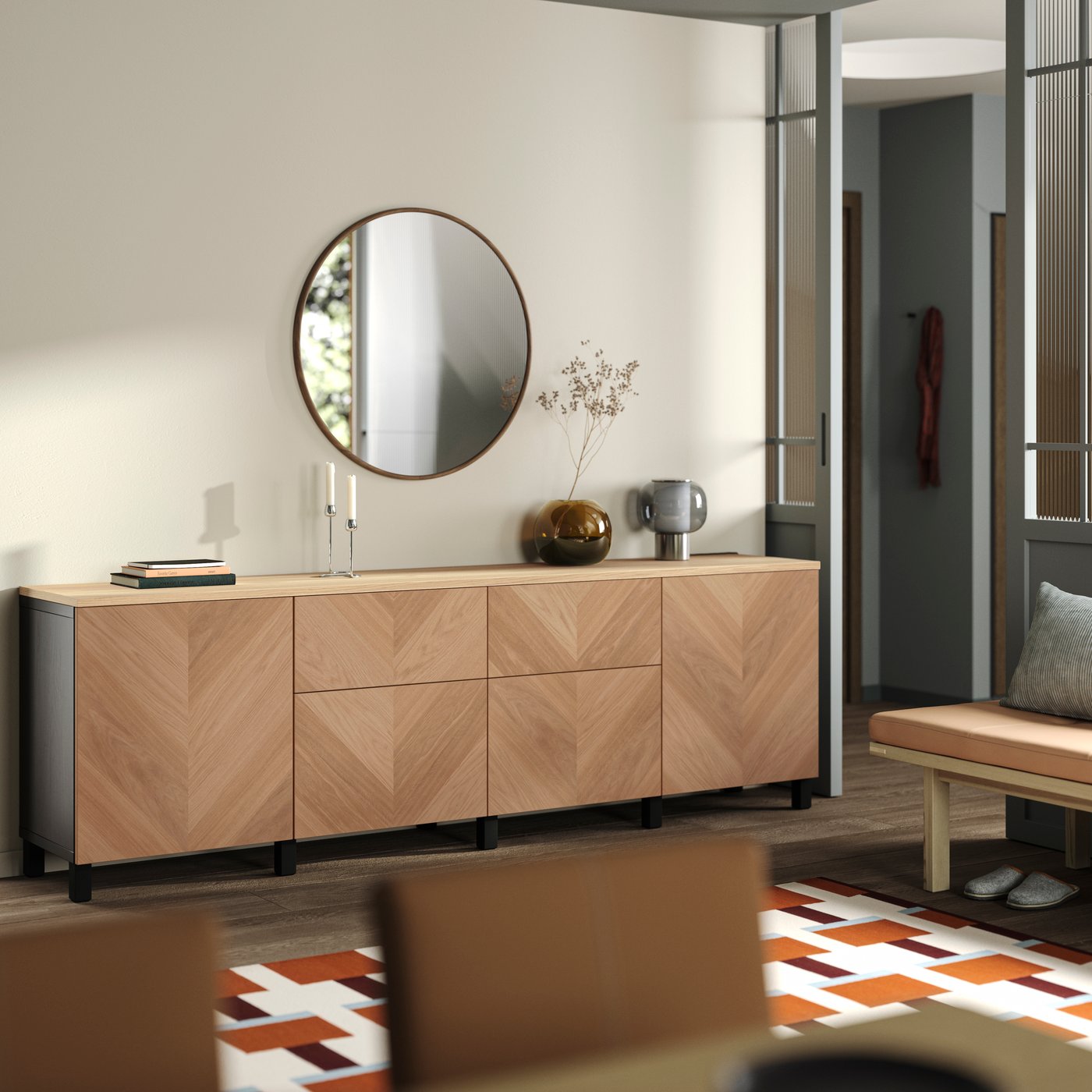 Light wood sideboard with a round mirror and decorative accents in a modern living space.