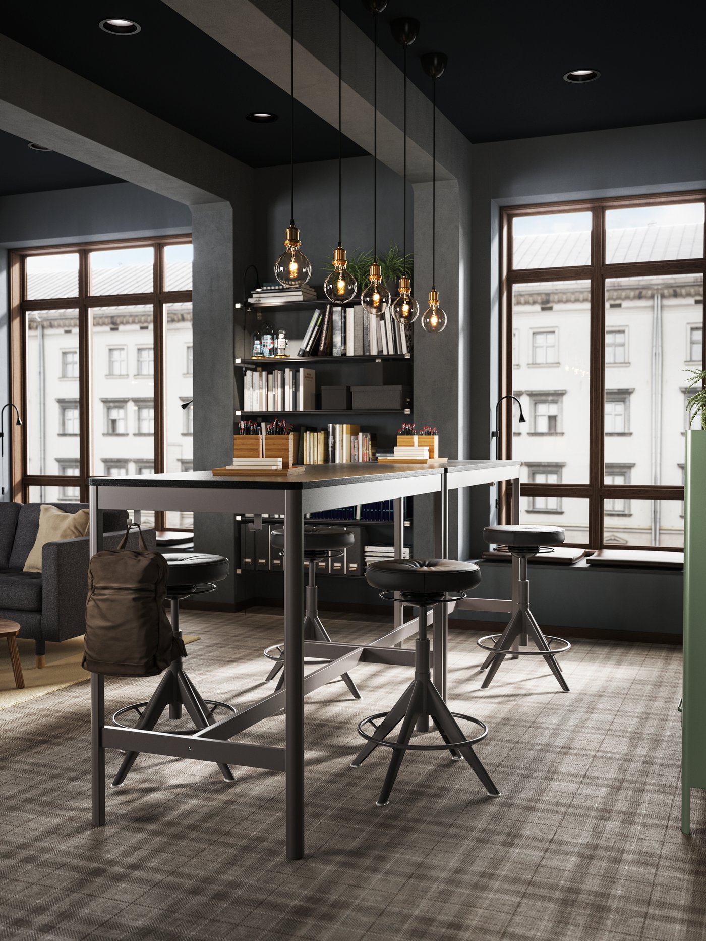 Two high IDÅSEN black/dark grey tables placed close to a large window creating a standing meeting zone.