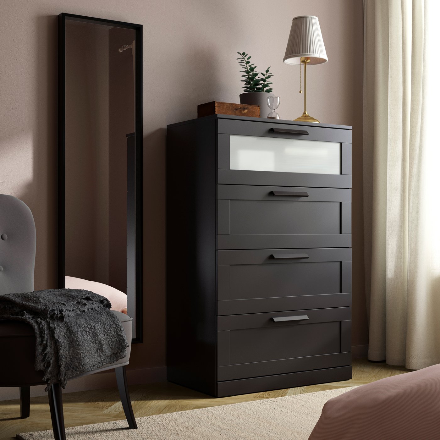 A black/frosted glass BRIMNES chest of 4 drawers in the bedroom