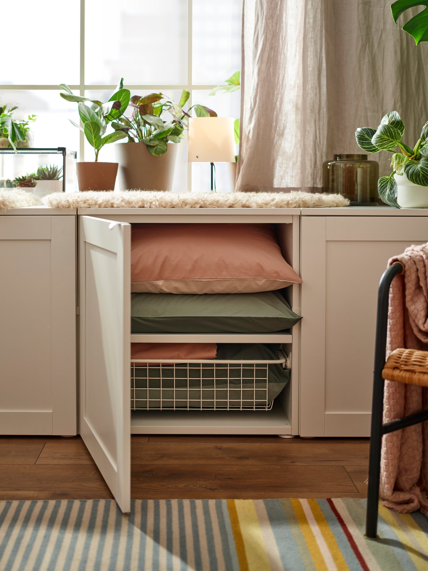A white HJÄLPA shelf in the living room