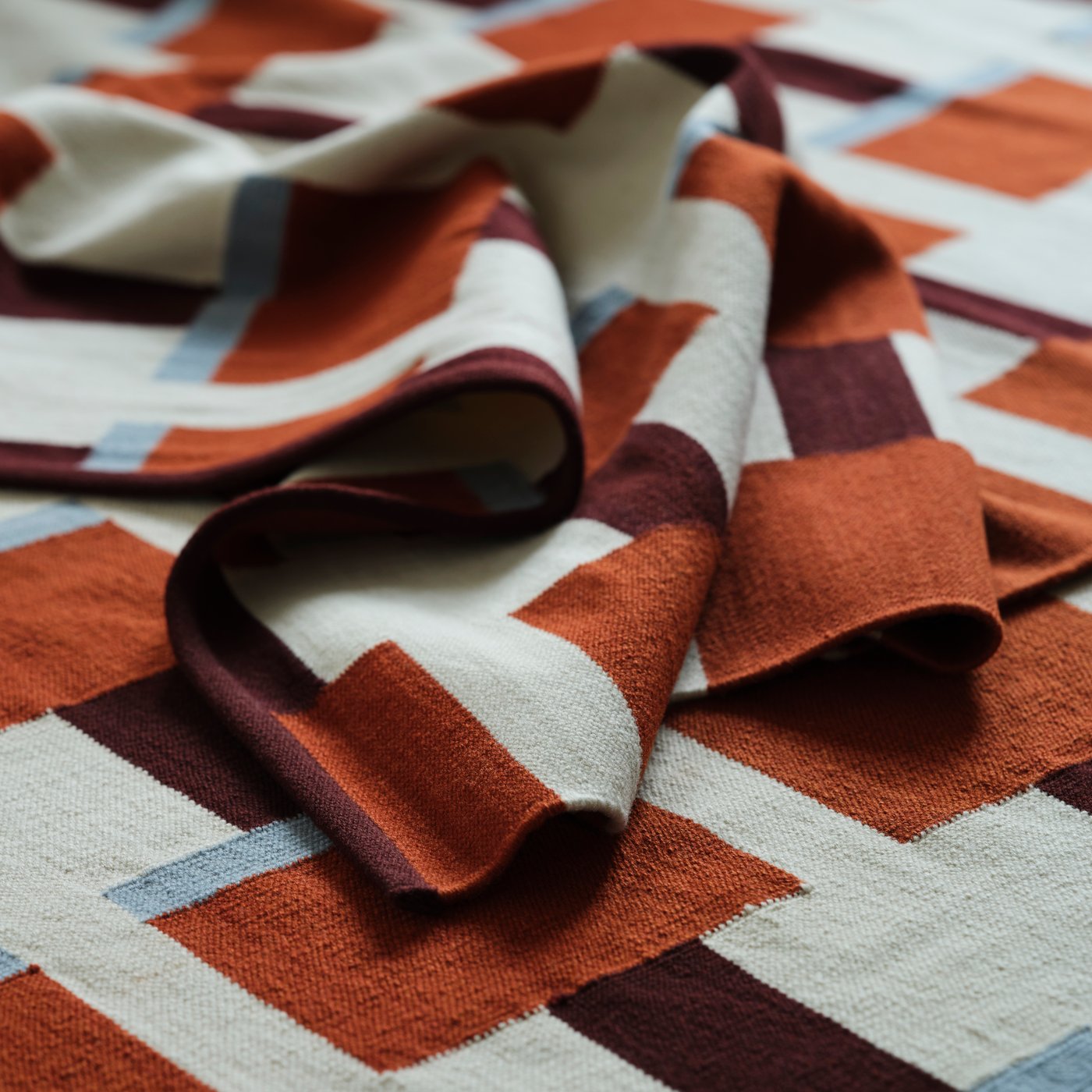 A white/brown/light blue handwoven STOCKHOLM 2025 rug, flatwoven