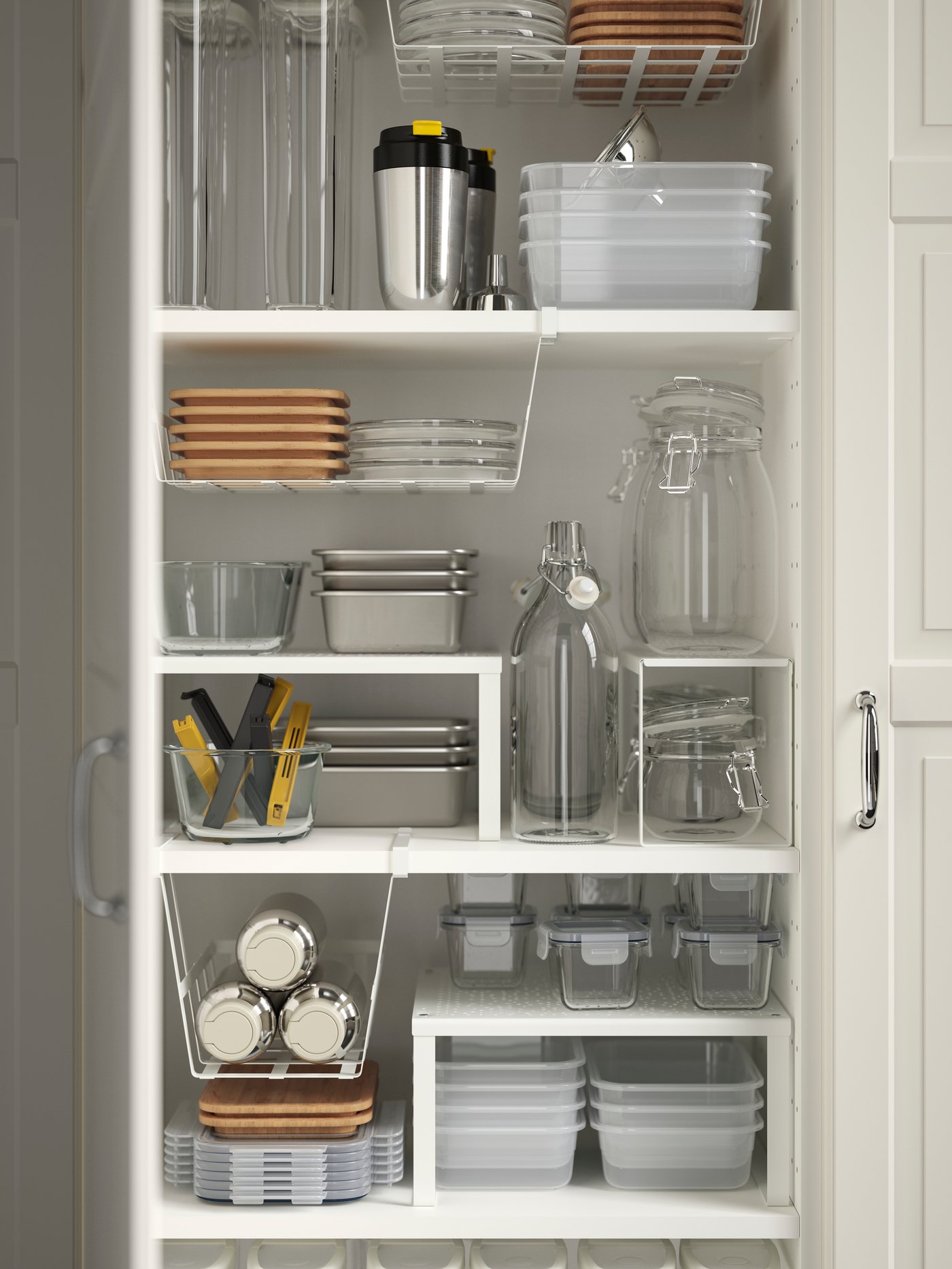 A white kitchen cabinet with shelves has several kitchen items stored on VARIERA shelf inserts and in PÅLYCKE wire baskets.