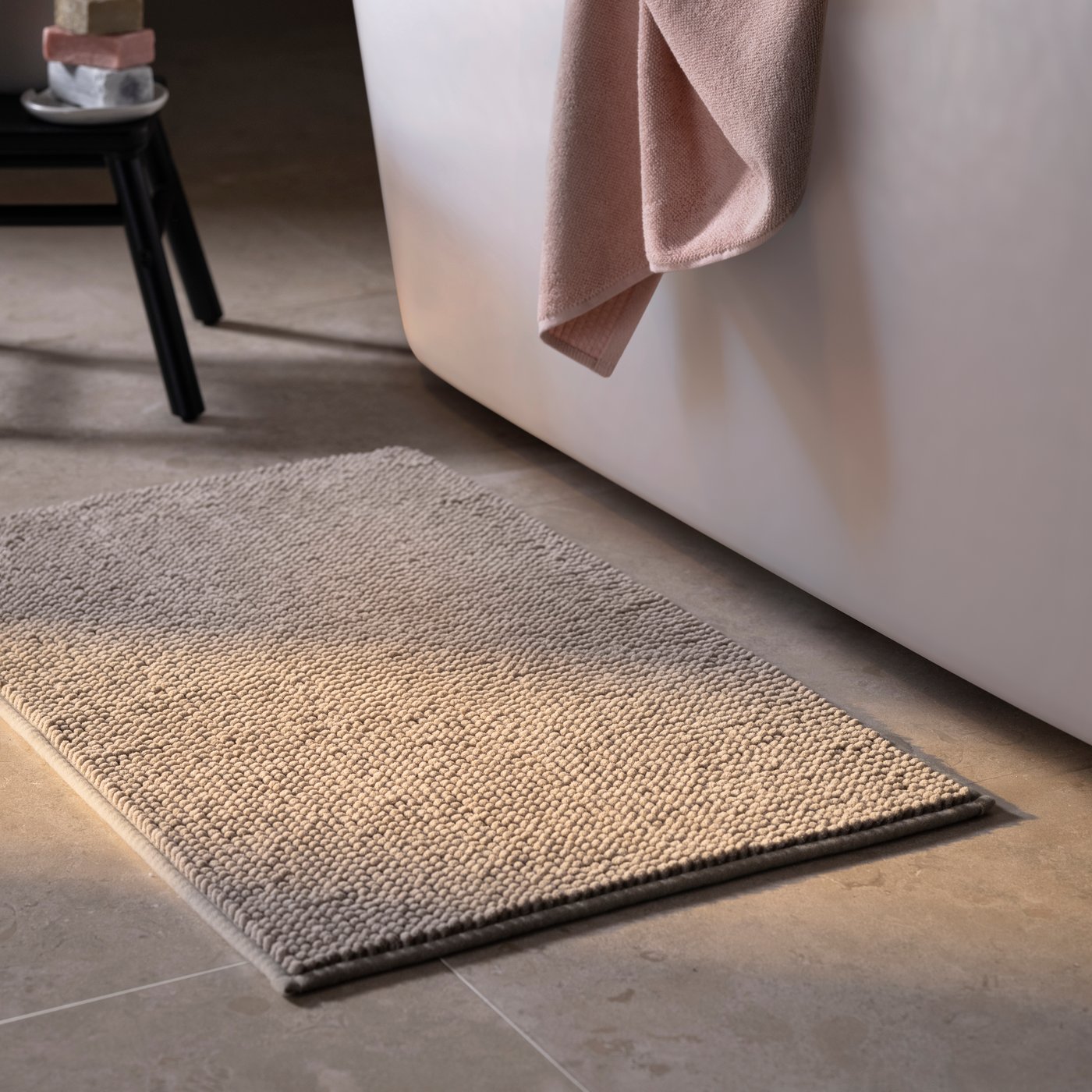 A dark beige TOFTBO bath mat