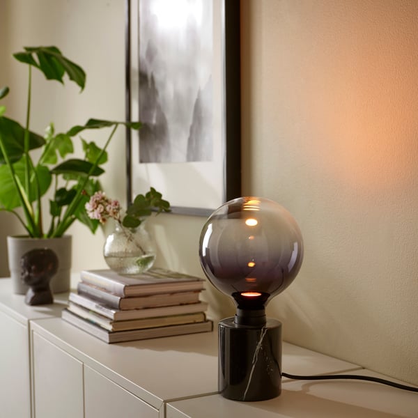 A black MARKFROST table lamp with light bulb