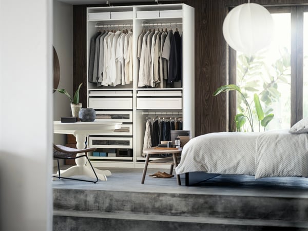 A bedroom with a raised floor and a wardrobe closet.