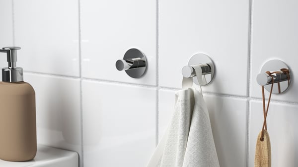 A chrome-plated SKOGHALL hook, self-adhesive