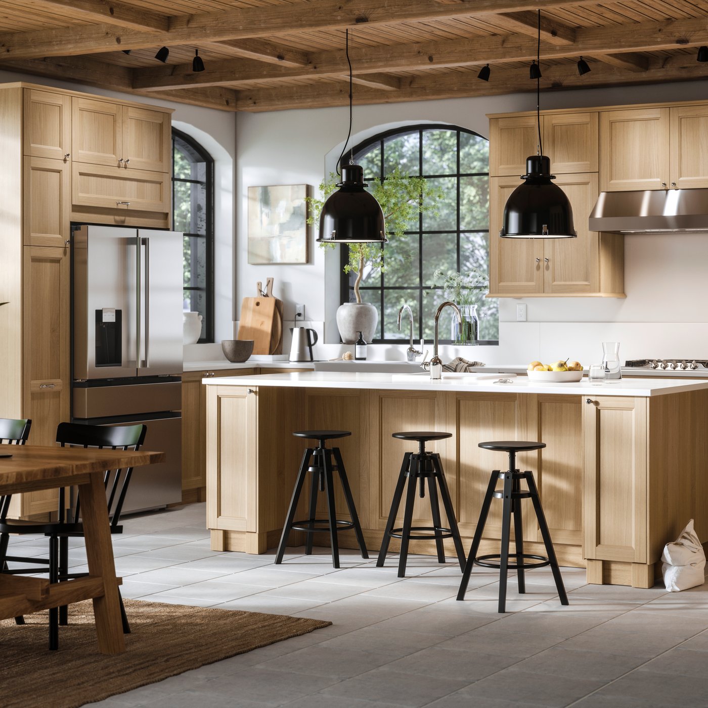 Bright, modern kitchen with wood cabinetry, large island, pendant lights, and dining table.