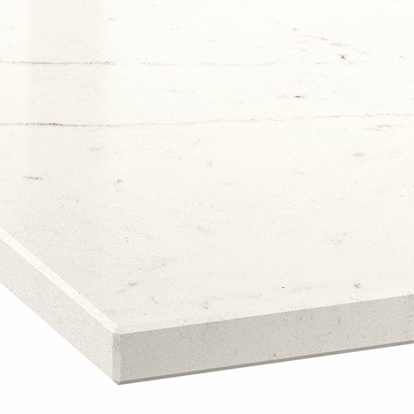 Close-up of a white countertop with faint gray veining and a smooth, polished surface.