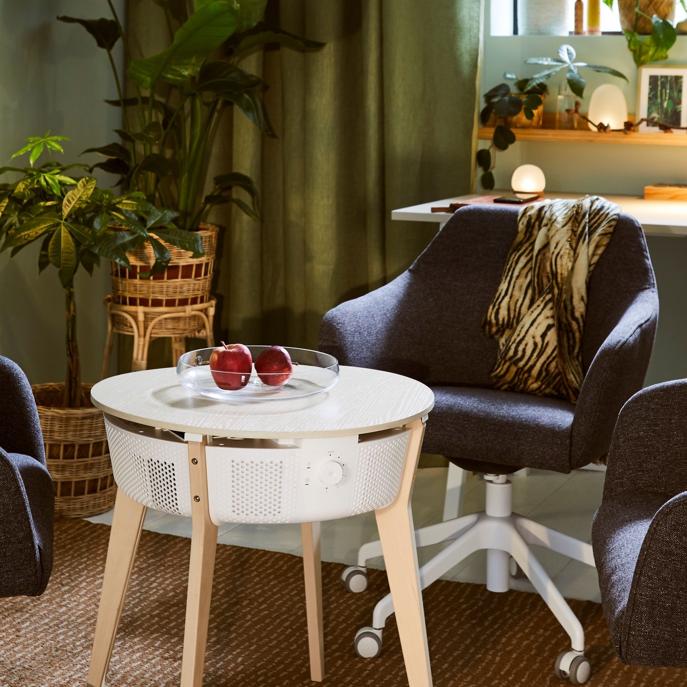 TOSSBERG conference chairs around a STARKVIND table with air purifier in a room with curtains and plenty of plants.