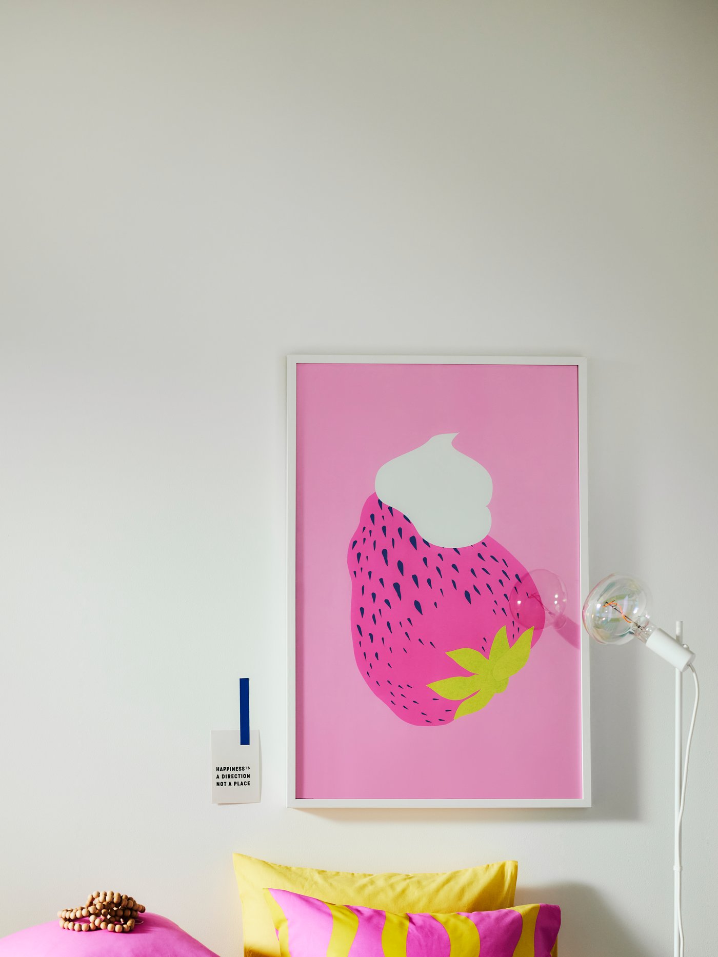 A set of 9 PJÄTTERYD pictures showing coastal scenes on a pale blue wall above a white MILSBO glass-door cabinet.