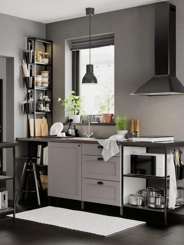 A contemporary kitchen with grey walls and floors with an ENHET kitchen with grey fronts and anthracite/grey frames.