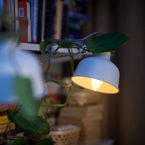 The part of a RANARP work lamp in off-white where the cord goes through the shade is shown against a white background.