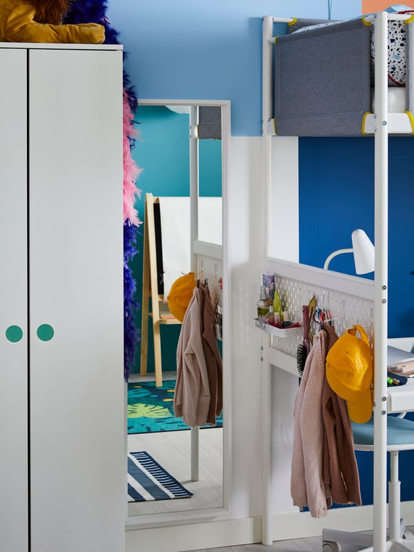 At the end of a VITVAL loft bed, a dressing corner is created with a NISSEDAL mirror and a pegboard for accessories.