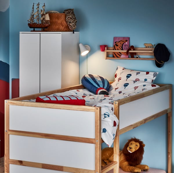 A light white stained pine FLISAT wall storage in the bedroom