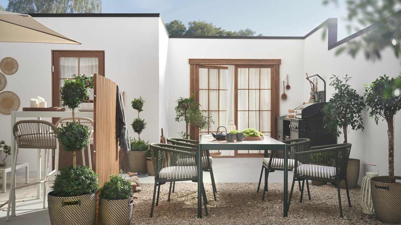 An in/outdoor dark grey/beige RÅGKORN plant pot outside