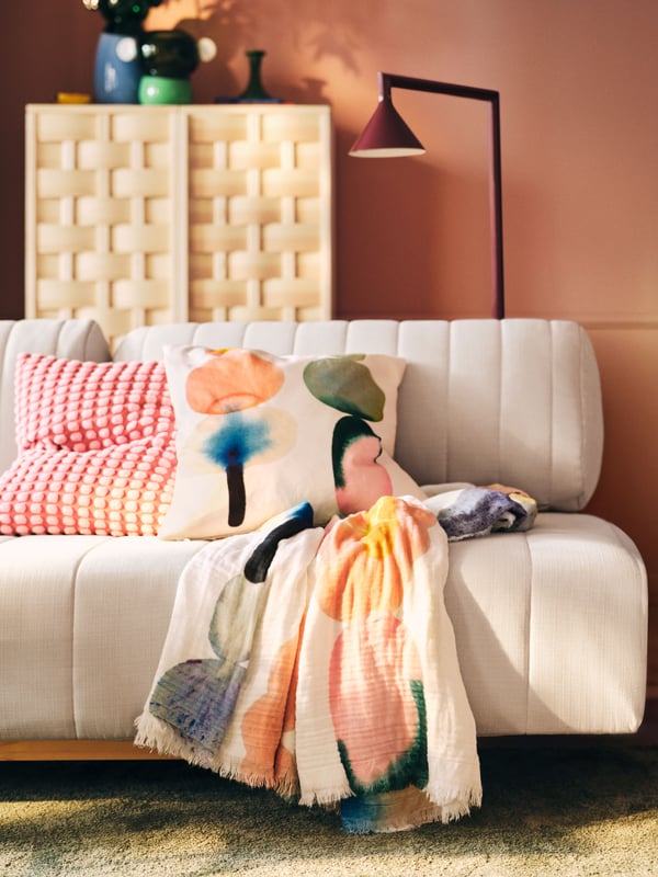 A white/multicolour IKEA PS 2026 throw in the living room