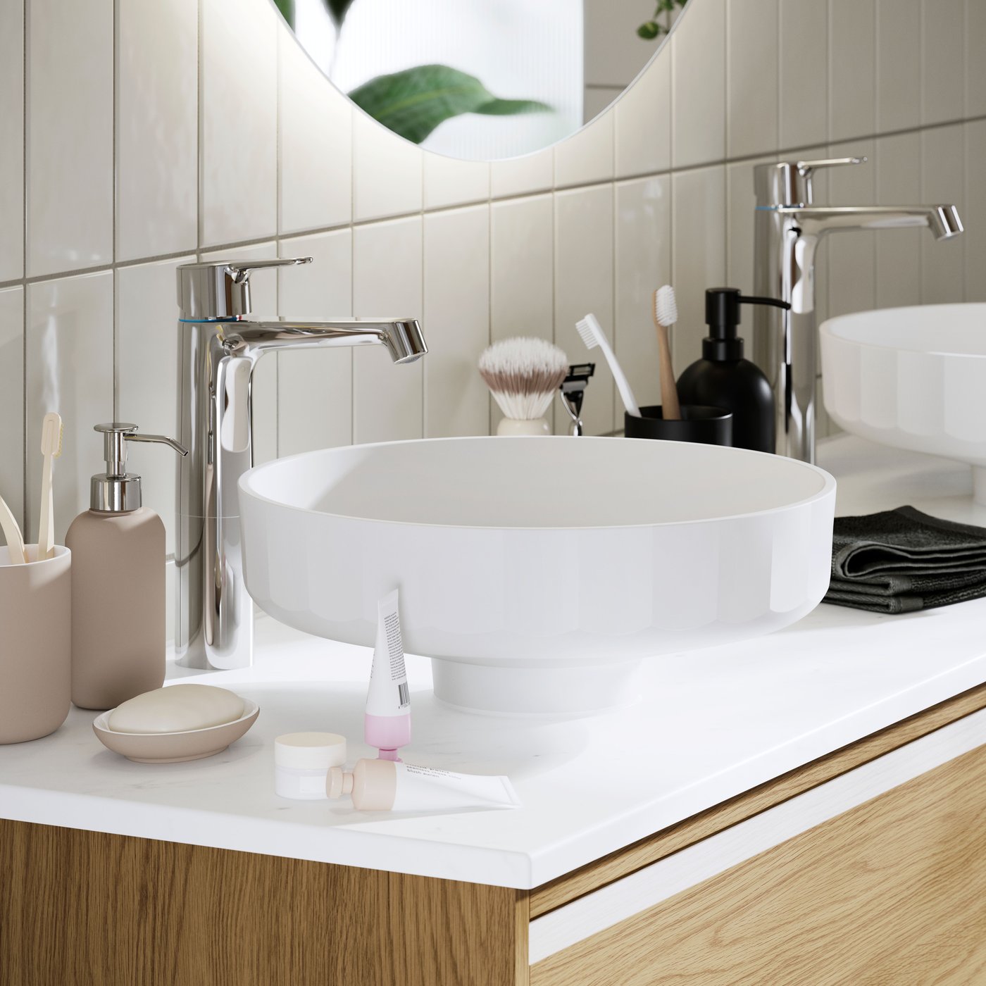 A modern bathroom with LERSJÖN countertop wash-basin, chrome taps, and stylish accessories on a wooden vanity unit.