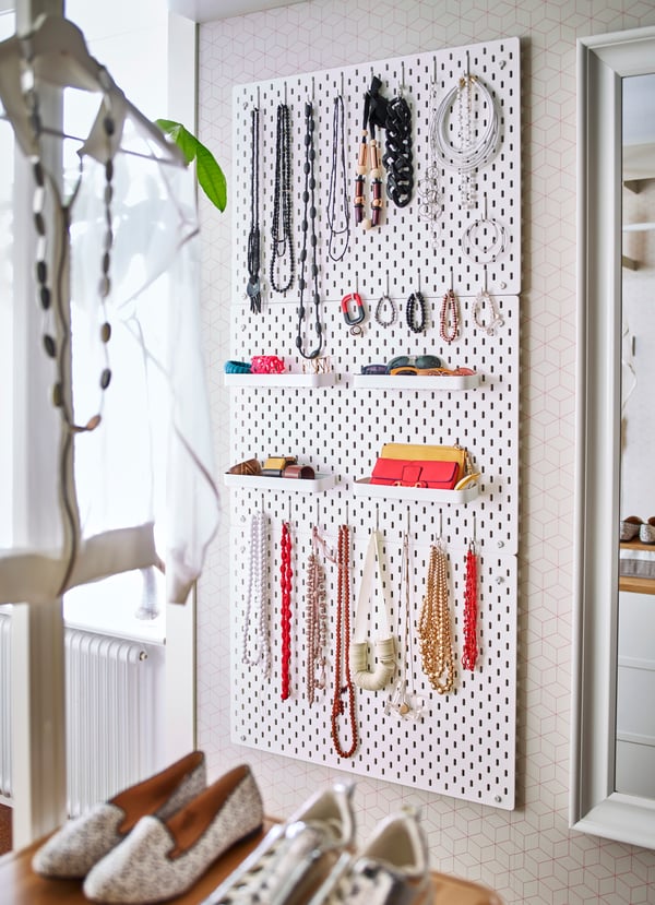 A white SKÅDIS pegboard in the bedroom
