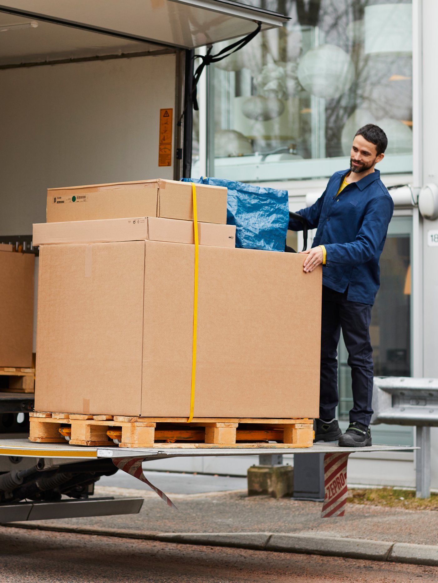 An IKEA delivery man delivering to a customers home.