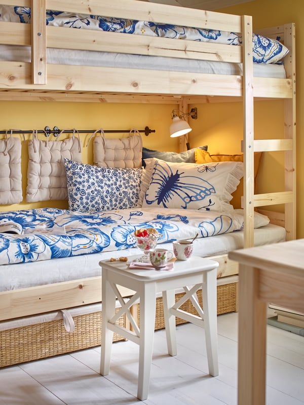 a bunk bed with blue and white pillows