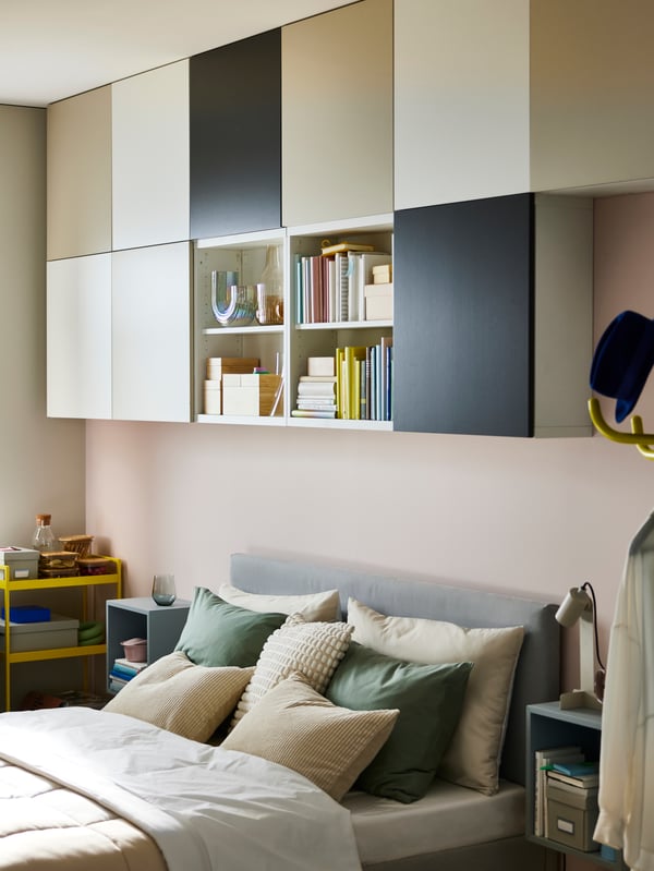 Eleven BESTÅ frames on a wall. Nine have LAPPVIKEN doors in white, dark grey and light grey biege on them and two are open.