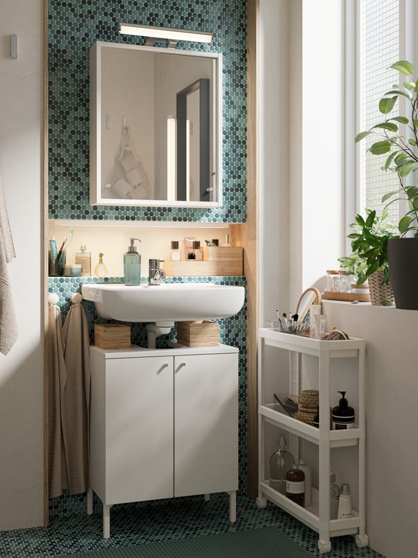 A white VESKEN trolley in the bathroom