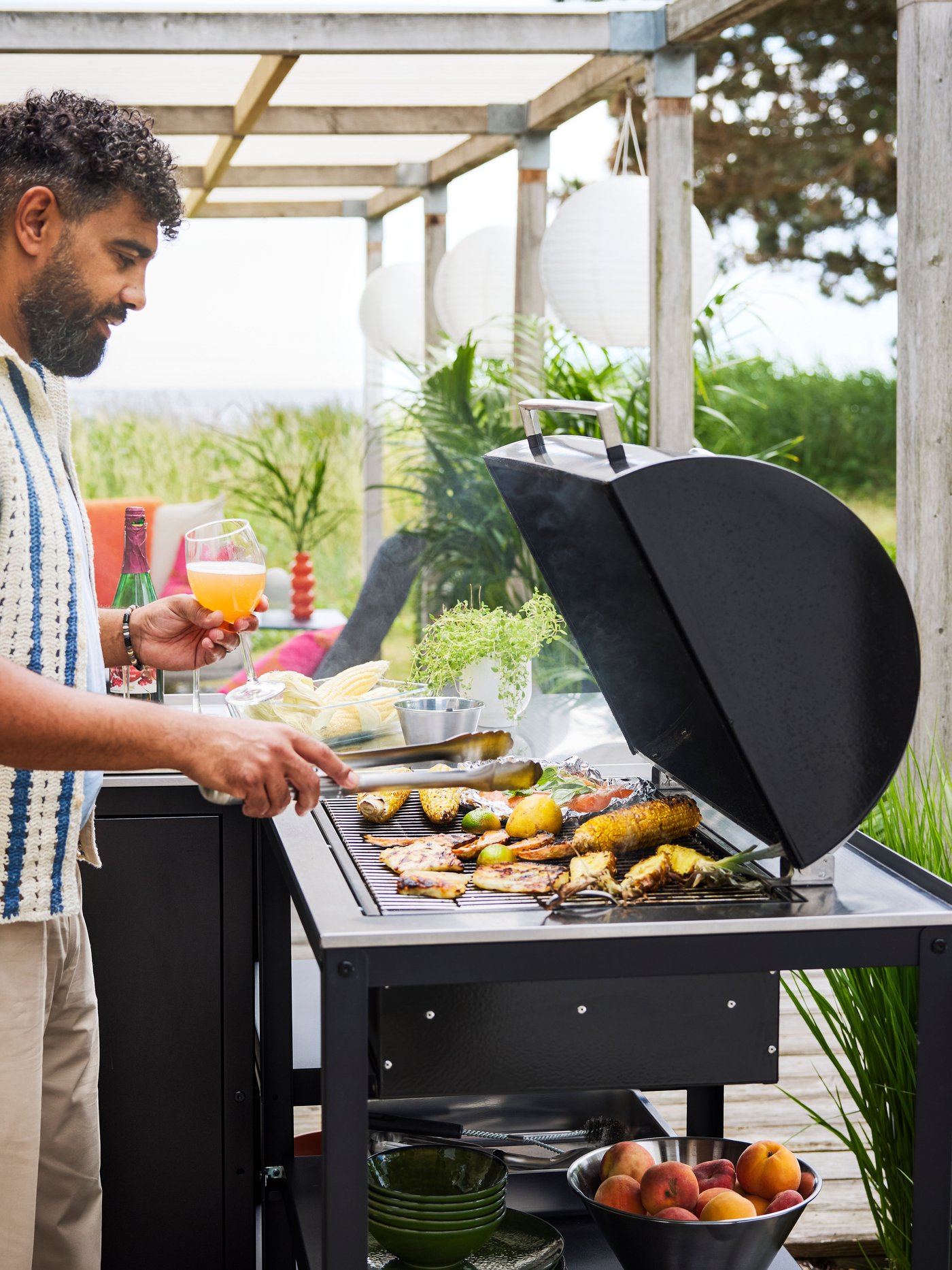A stainless steel GRILLTIDER 2-piece barbecue tools set outside