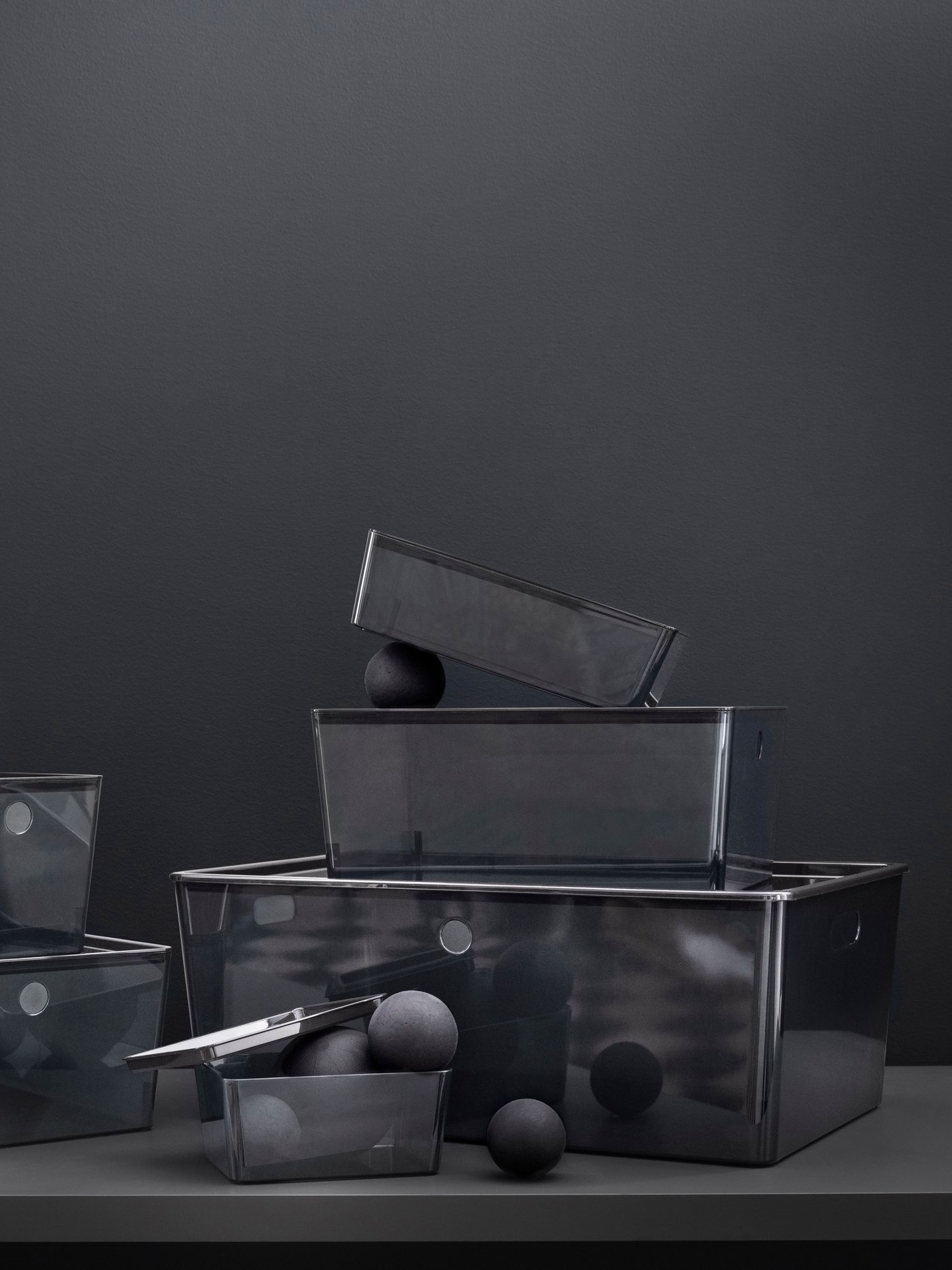 Furnishing ideas by Ronos Chen: Black KUGGIS boxes in different sizes are stacked on top of each other.