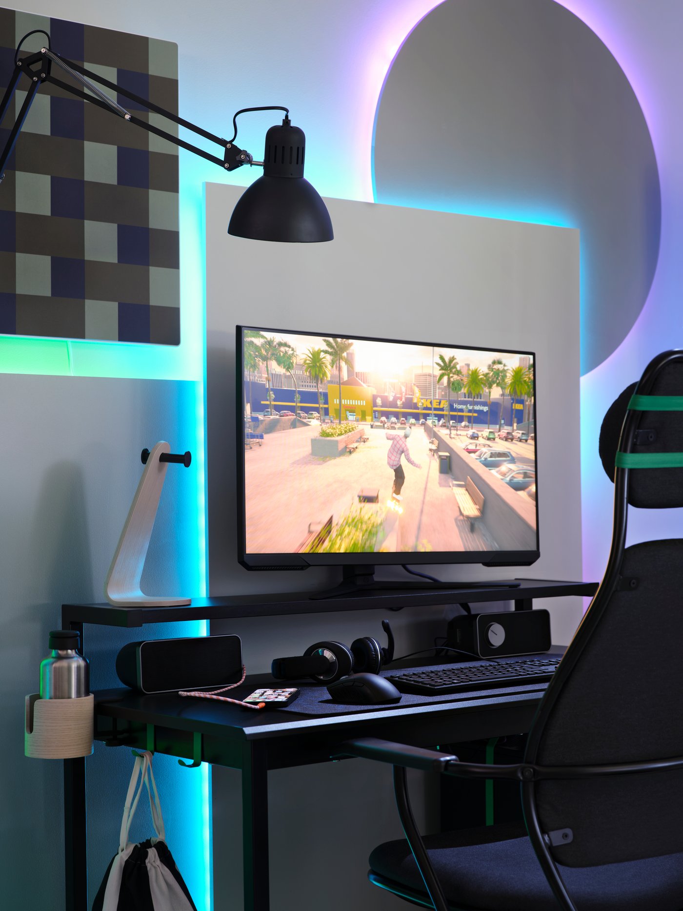 A black PC gaming setup has a big rectangle and circle behind it that are backlit by unseen VATTENSTEN LED lighting strips.