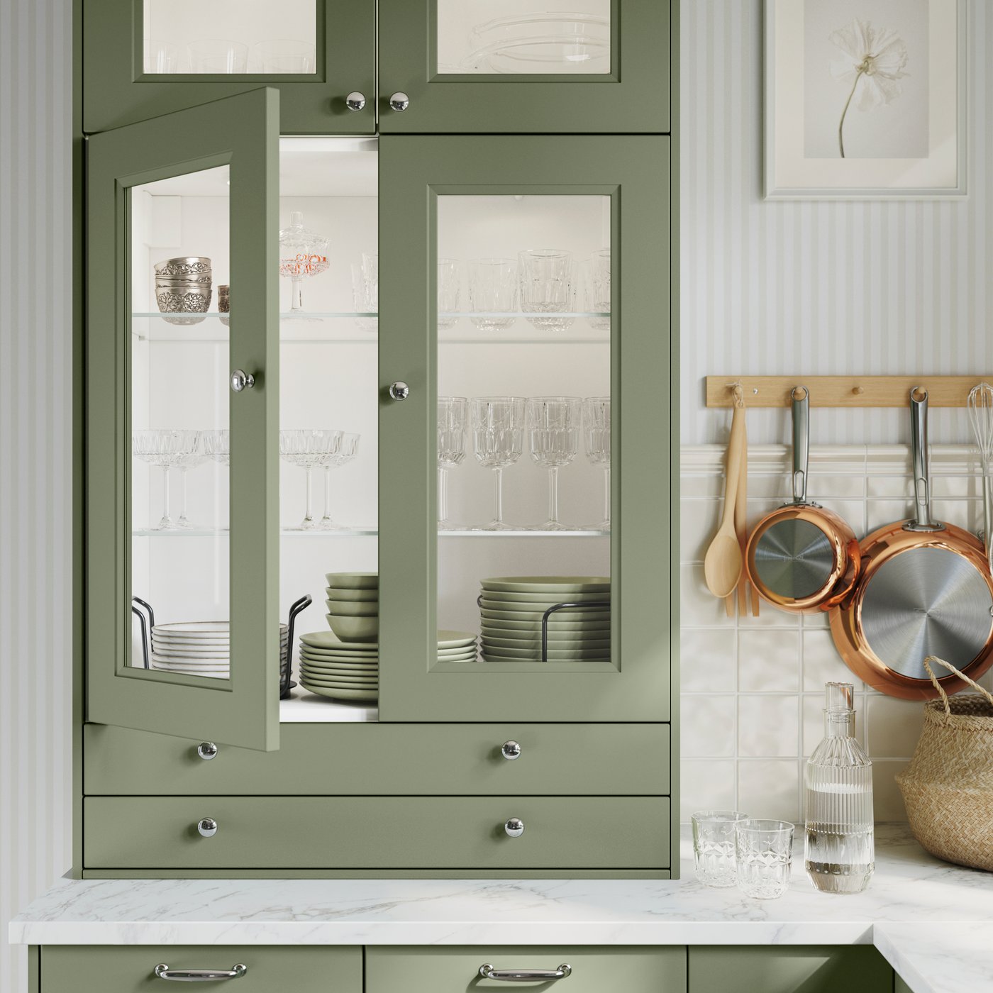 A grey-green AXSTAD glass door open to show green dinnerware